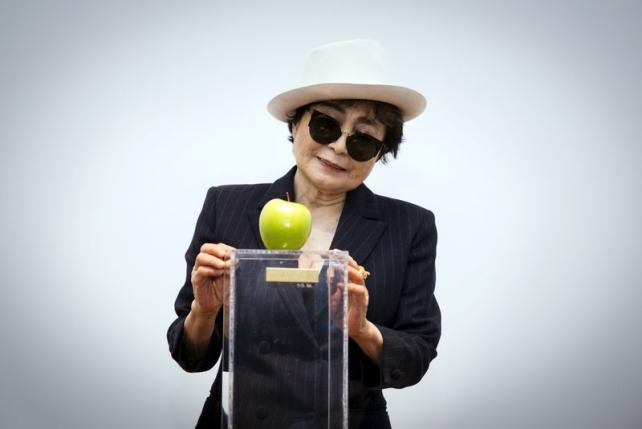 Artist Yoko Ono interacts with the exhibit "Apple" at the Museum of Modern Art exhibition dedicated exclusively to her work in New York